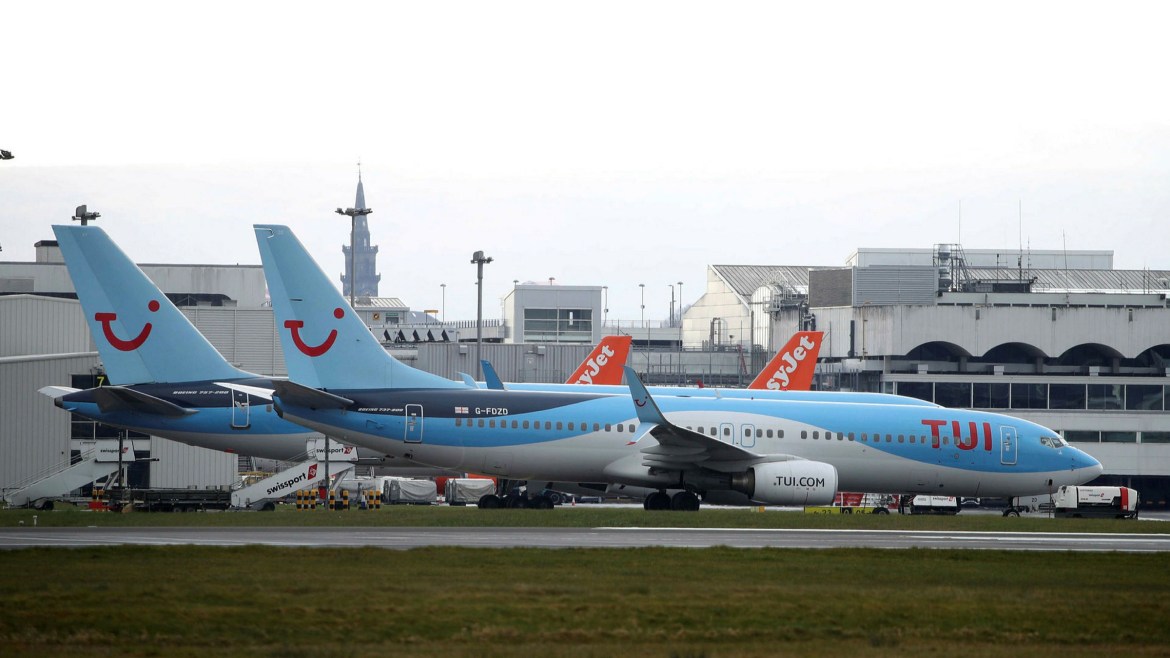 TUI 737-800 parked at on stand at Manchester Airport