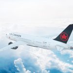 Aerial in-flight view of Air Canada Boeing 787 Dreamliner flying high above the clouds.