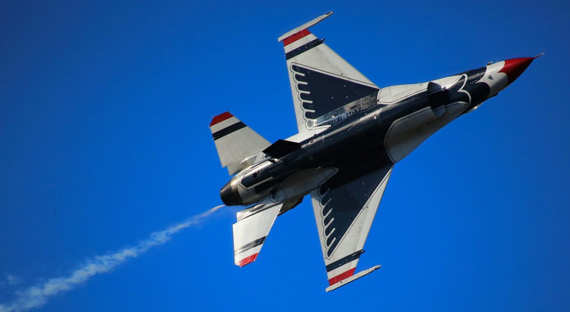 A jet flying against a blue sky.